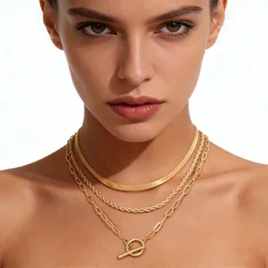 Three-layer gold necklace set featuring snake chain, rope link, and OT toggle paperclip chain
