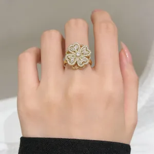 Close-up of rotatable clover ring in gold with sparkling pave-set cubic zirconia stones