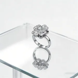 Macro detail of rotating clover ring with micro-set zircons on reflective surface