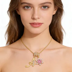 Gold letter A necklace with pink gemstone flower pendant on a female model