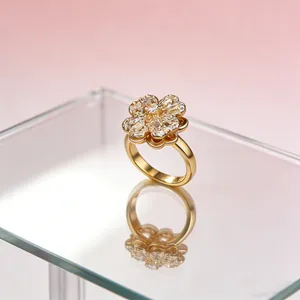 Close-up of golden spinning clover ring with heart-shaped petals and zircon stones