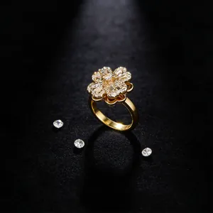 Macro shot of spinning clover flower ring with cubic zirconia in gold plated finish