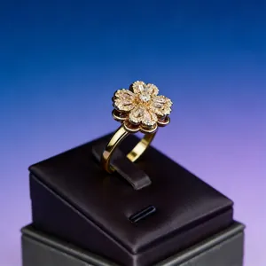 Macro shot of gold clover ring with micro-set zircons on luxury leather display