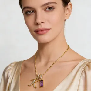 Collana dorata con lettera K in cristallo e pendente in zircone viola su modella