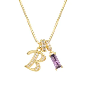 Dettaglio del ciondolo lettera B dorata con cristalli pavé e pietra di zircone viola