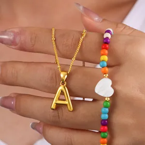 Collar chic dorado con colgante de letra A y cuentas de colores en una cadena delicada