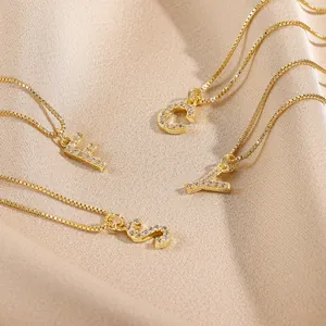 Gold-plated 14k box chain necklaces featuring cubic zirconia initial pendants on silk cloth