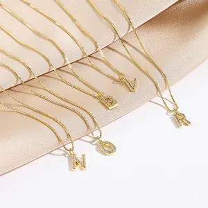 Detail of 14k gold plated letter pendants N, O, B, V, R with cubic zirconia on box chains