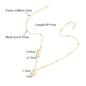 Detail of gold letter M pendant and infinity charm with 45+5cm chain size specs