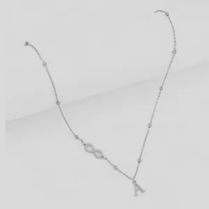 Silver infinity symbol and letter A pendant necklace with bead chain on gray background