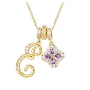 Gold letter E necklace featuring a purple clover pendant with sparkling zircons