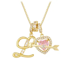 Golden necklace with letter L and pink heart pendant featuring Cupid arrow and crystals