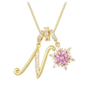 Letter N pendant necklace in gold finish with pink flower and sparkling zircons