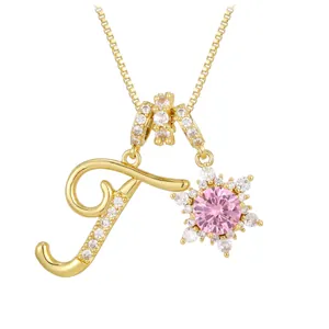 Golden letter J necklace with a pink snowflake flower pendant and sparkling zircons