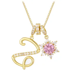 Gold letter S necklace with pink snowflake pendant and zircon accents on box chain