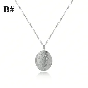 Vintage silver oval locket necklace with floral engraving and slim cross chain on white background