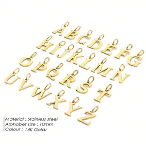 Detail of 14K gold plated stainless steel initial letter pendants in a clean flat lay view
