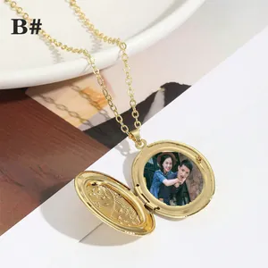 Vintage gold oval locket necklace with delicate floral pattern on an elegant chain