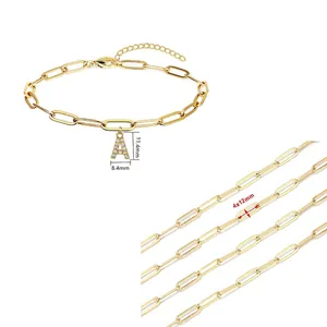 Macro detail of gold paperclip chain and A-letter pendant with zircon inlay