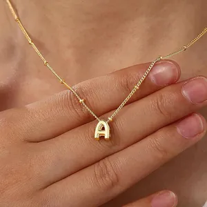 Detail of gold satellite chain with a 3D polished letter A pendant on a model