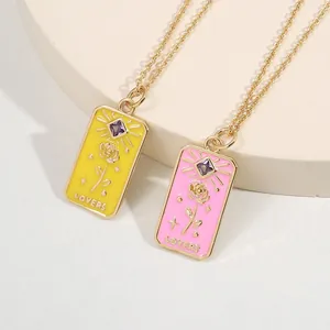 Detail of tarot style rectangular pendant with purple gemstone and lovers engraving