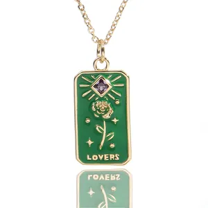 Detail of retro tarot-style necklace featuring a green enamel rose pendant and purple gem