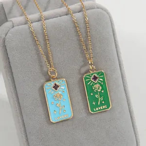 Detail of tarot style enamel lovers pendant necklace with rose and purple crystal inlay