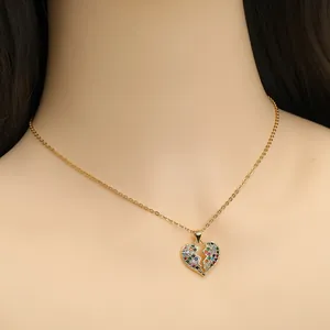 Collana dorata con ciondolo a cuore in zirconi multicolore su una modella elegante