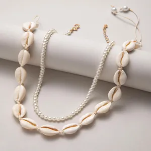 Double-layered beach style necklace featuring natural shells and elegant white pearls