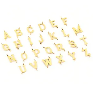 Macro view of 26 gold-plated letter charms with double connectors for DIY jewelry