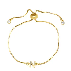 Detail of adjustable gold box chain bracelet with cubic zirconia letter N charm