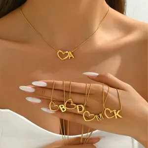 Polished gold initial letter necklace featuring heart detail on a fine cable chain