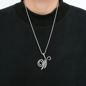 Close-up of hip hop pendant necklace with cursive letter W paved in cubic zirconia