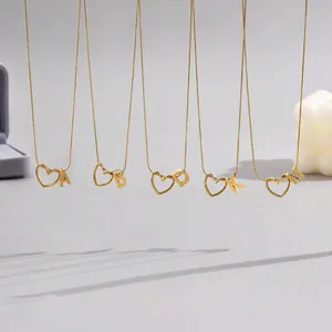 Detailed close-up of golden heart-shaped alphabet necklaces with sleek snake chain links