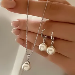 Elegant pearl jewelry set with necklace and drop earrings in a polished silver finish