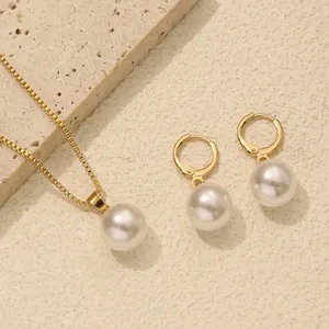 Detailed view of elegant pearl necklace and matching earrings set on stone texture