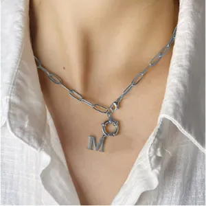 Silver paperclip chain necklace with a capital letter M pendant and round OT toggle clasp