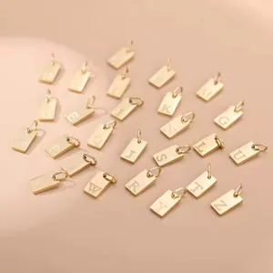 Detailed view of 26 golden stainless steel alphabet charms for DIY jewelry making