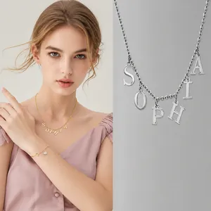 Detailed close-up of a custom gold and silver name necklace with SOPHIA letter pendant
