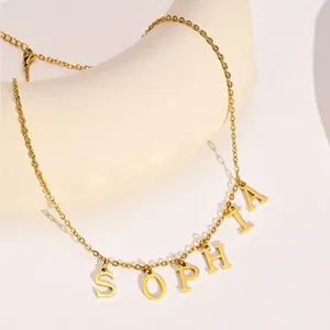 Detailed shot of gold plated necklace featuring SOPHIA letter pendants and lobster clasp