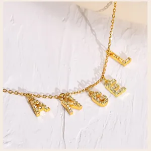 Detail of gold-plated stainless steel necklace with micro-pave zircon ANGEL letter pendant