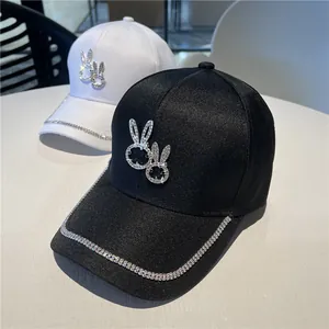 Detail of bunny motif with sparkling rhinestones on baseball cap and brim decoration