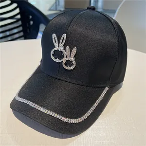 Black baseball cap with rhinestone bunny patterns and shimmering diamond rim decoration