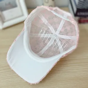 Detail of pink lace mesh baseball cap showing interior structure and floral embroidery