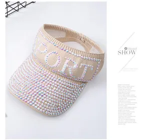 Close-up of sparkling rhinestones and SPORT embroidery on a beige sun visor cap