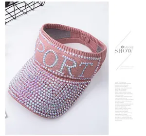 Close-up of pink knitted visor with crystal rhinestones forming the word SPORT