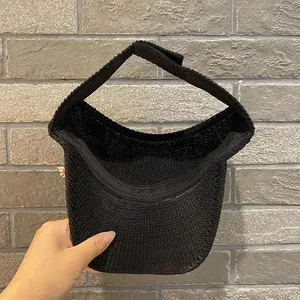 Close-up of black knitted sun visor with adjustable velcro strap for outdoor UV protection