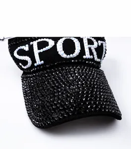 Detail of SPORT lettering with silver sequins and black rhinestones on a sun visor hat