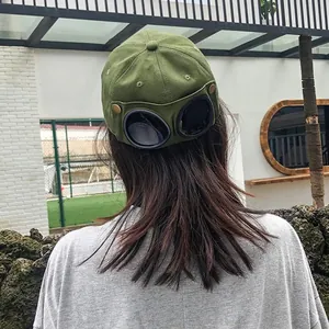 Detail shot of the integrated pilot goggles on the back of the military green baseball cap