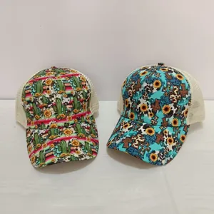 Detail of mesh trucker hats with cactus cross and sunflower prints on white mesh panels
